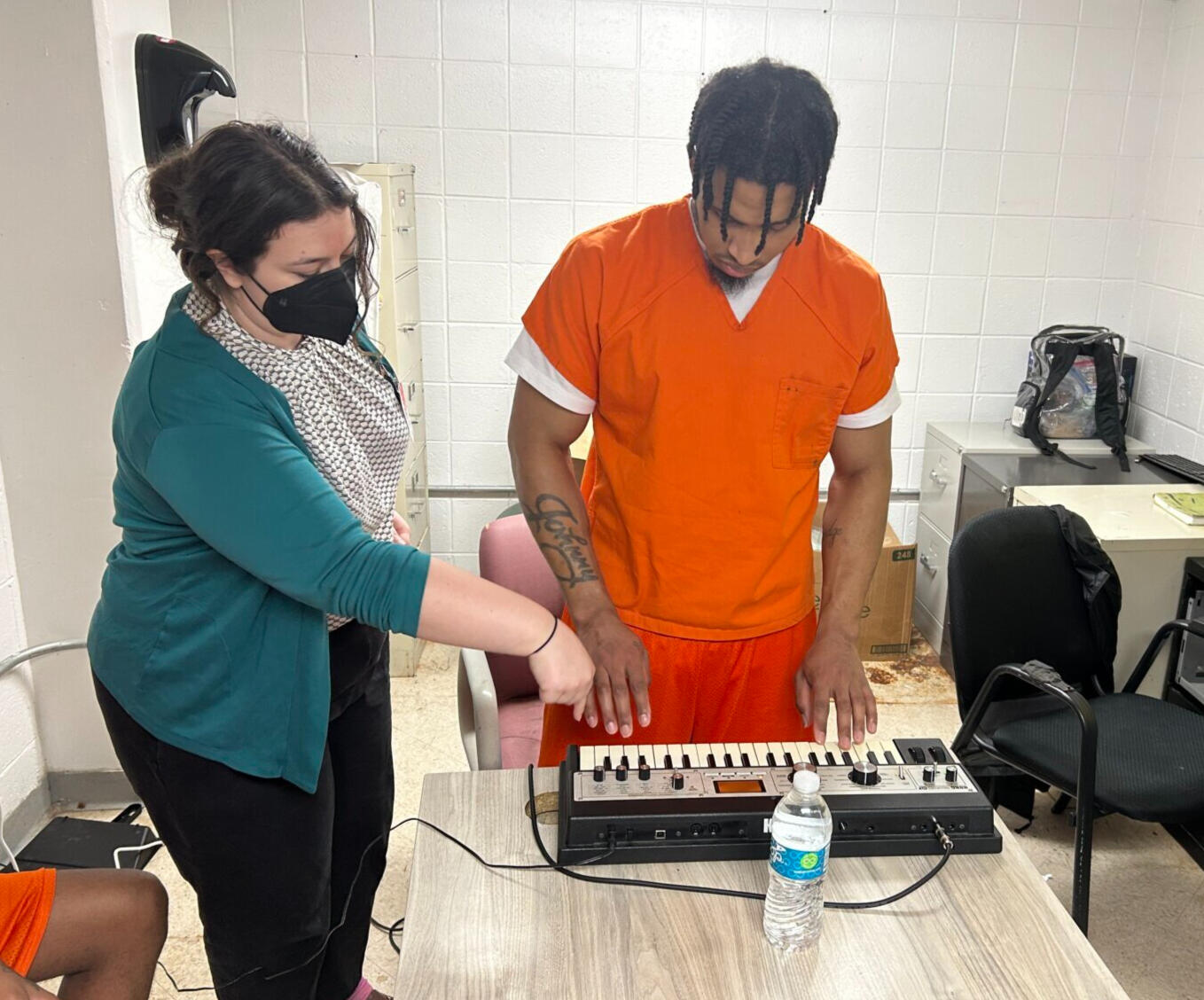 Project Poetic Justice Music Making (student at a synthesizer with a composer coaching him on how to use the instrument)